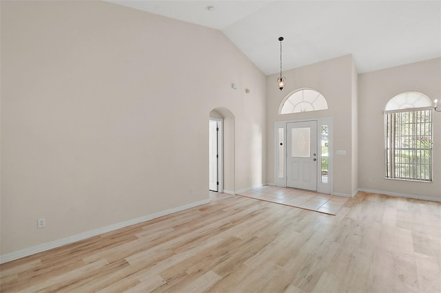 foyer featuring light wood-type flooring and lofted ceiling