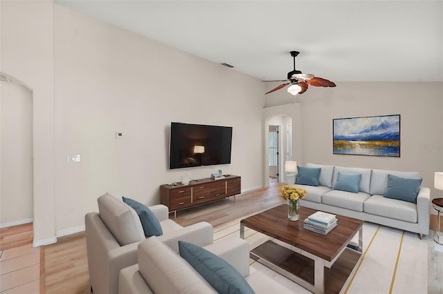 living room featuring ceiling fan, vaulted ceiling, and light hardwood / wood-style floors