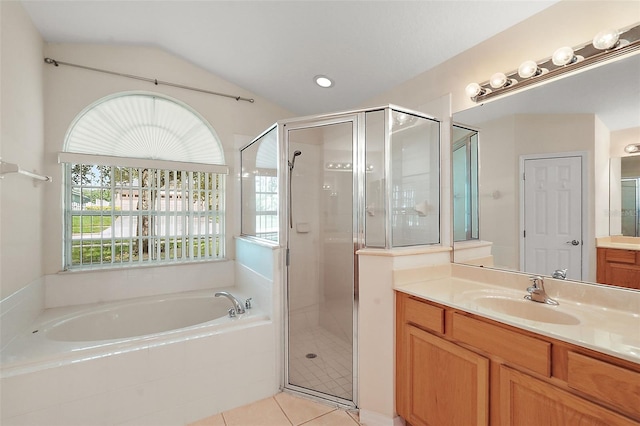 bathroom featuring vanity, separate shower and tub, tile patterned floors, and vaulted ceiling