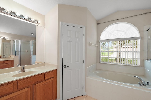 bathroom with vanity, lofted ceiling, separate shower and tub, and tile patterned flooring