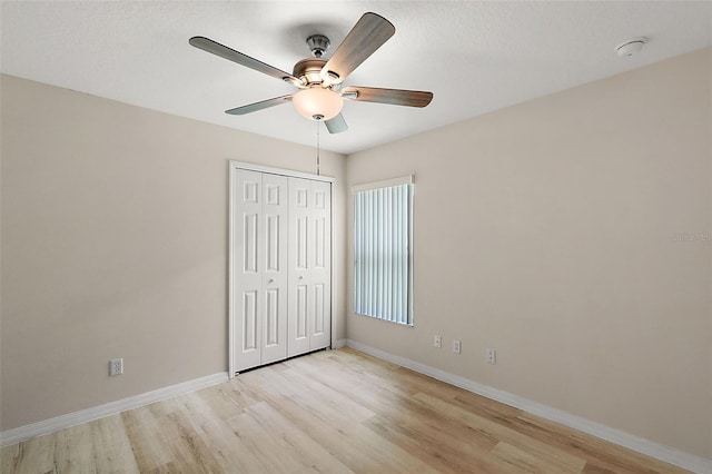 unfurnished bedroom featuring a closet, ceiling fan, and light hardwood / wood-style floors