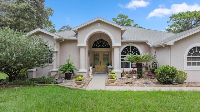 exterior space with a lawn and french doors