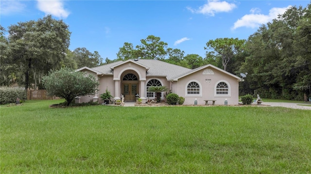 single story home featuring a front yard