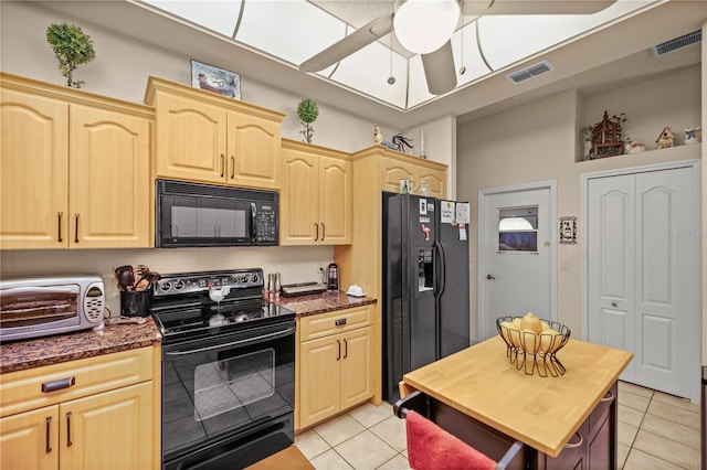 kitchen with black appliances, light brown cabinetry, light tile patterned flooring, and ceiling fan