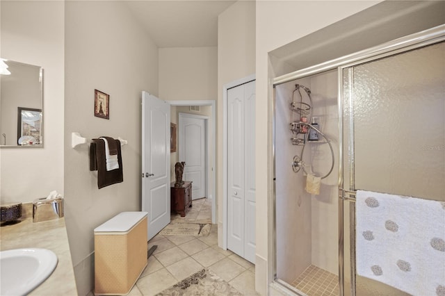 bathroom featuring vanity, an enclosed shower, and tile patterned floors