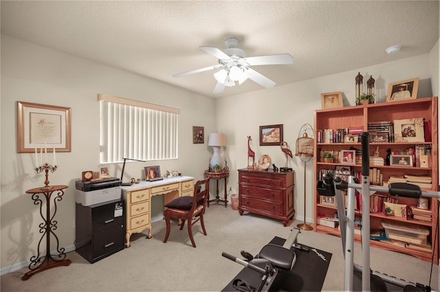 office area featuring light colored carpet, ceiling fan, and a textured ceiling