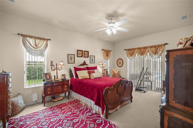 bedroom featuring ceiling fan and light carpet