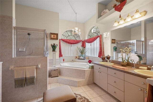 bathroom with plus walk in shower, tile patterned flooring, a notable chandelier, and vanity