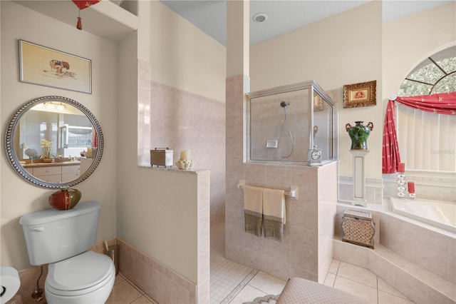 bathroom featuring toilet, tile patterned floors, and shower with separate bathtub