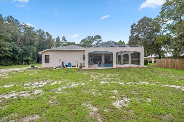 back of house with a lawn, a fenced in pool, and a patio