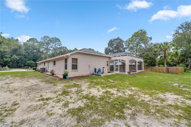 back of property featuring central air condition unit, a lawn, a patio, and a gazebo