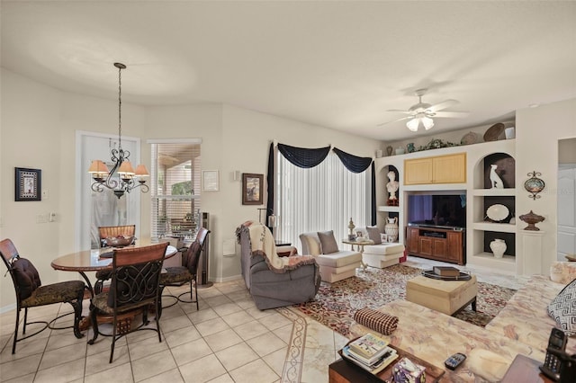 tiled living room featuring ceiling fan with notable chandelier