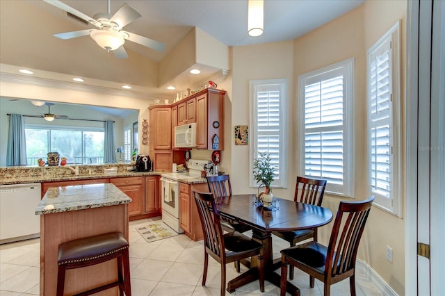 dining space featuring a healthy amount of sunlight, ceiling fan, and light tile patterned flooring