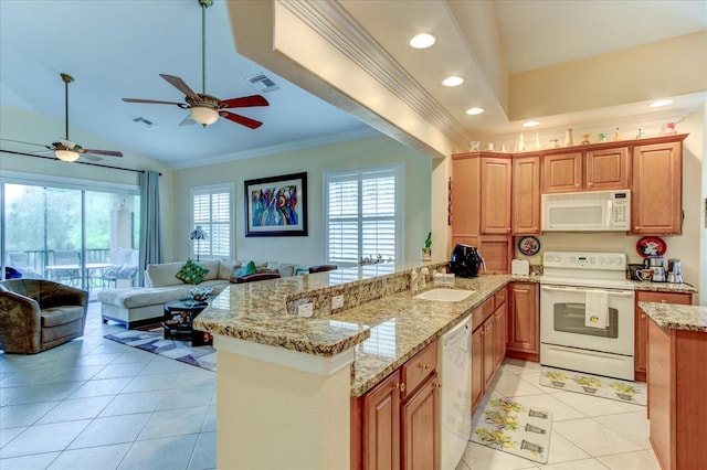 kitchen featuring white appliances, a wealth of natural light, kitchen peninsula, and ceiling fan