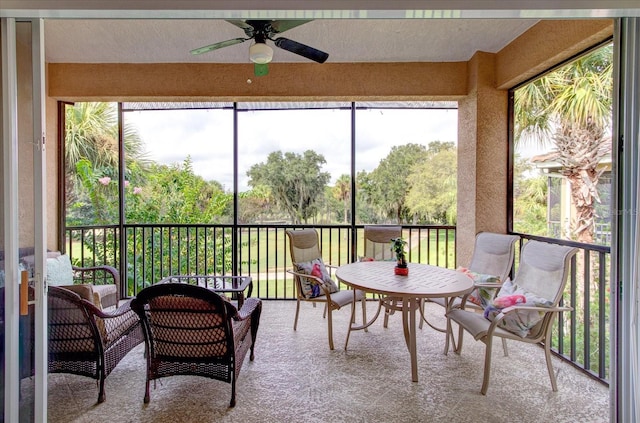 sunroom with a wealth of natural light and ceiling fan