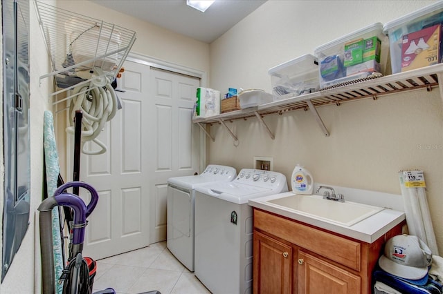 clothes washing area with cabinets, sink, independent washer and dryer, and light tile patterned flooring