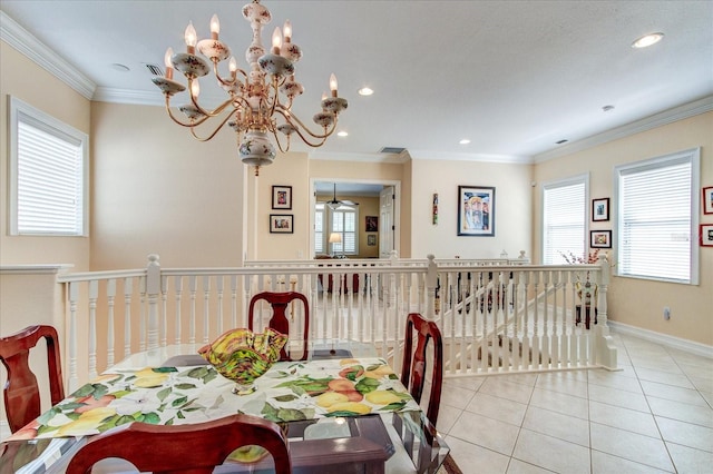 tiled dining area with ornamental molding, a healthy amount of sunlight, and a notable chandelier