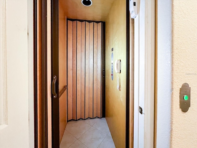 hall featuring light tile patterned floors