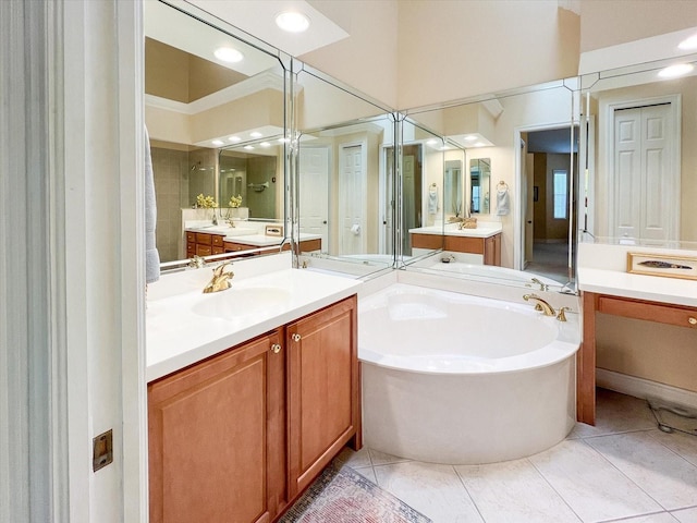 bathroom with a tub, tile patterned floors, and vanity