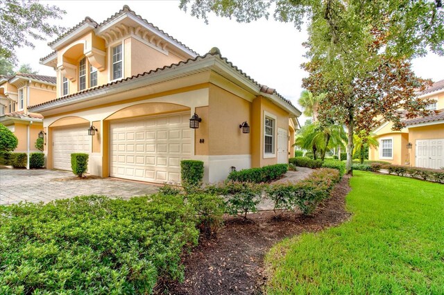 view of side of property with a yard and a garage