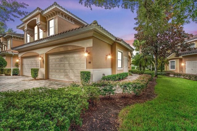 view of front facade with a garage and a yard