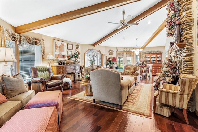 living room with dark wood-type flooring, ceiling fan with notable chandelier, and vaulted ceiling with beams