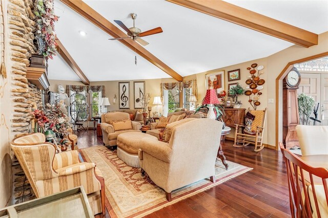 living room featuring plenty of natural light, ceiling fan, vaulted ceiling with beams, and dark hardwood / wood-style flooring