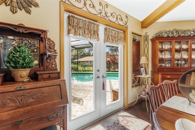 doorway to outside with french doors, wood-type flooring, and beam ceiling