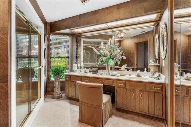 bathroom featuring vanity, tile patterned floors, and walk in shower