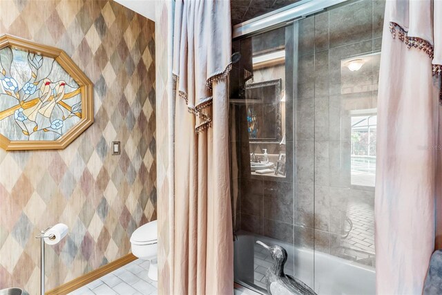 bathroom with tile patterned flooring, toilet, and enclosed tub / shower combo