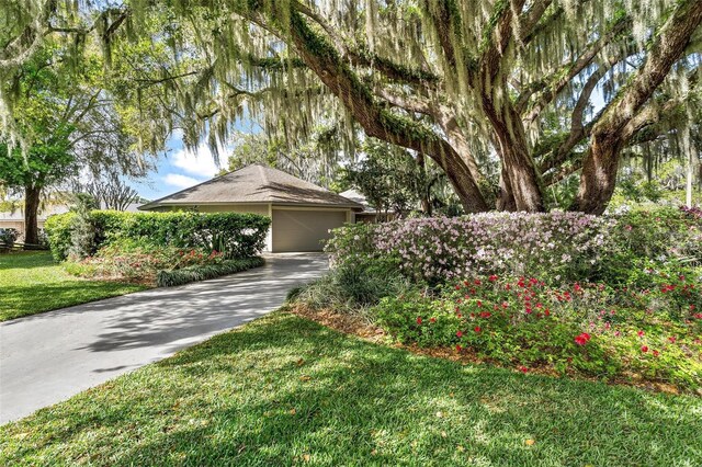 view of front of property with a garage and a front yard