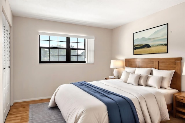 bedroom featuring hardwood / wood-style floors and a closet