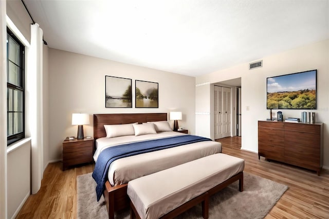 bedroom featuring a closet and light wood-type flooring