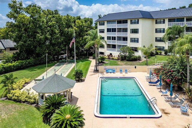 view of swimming pool with a lawn and a patio