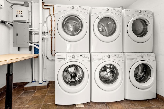 washroom with electric panel, washing machine and dryer, and stacked washer and dryer