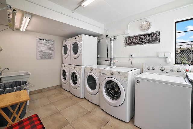 laundry area with light tile patterned floors, independent washer and dryer, and stacked washer / dryer