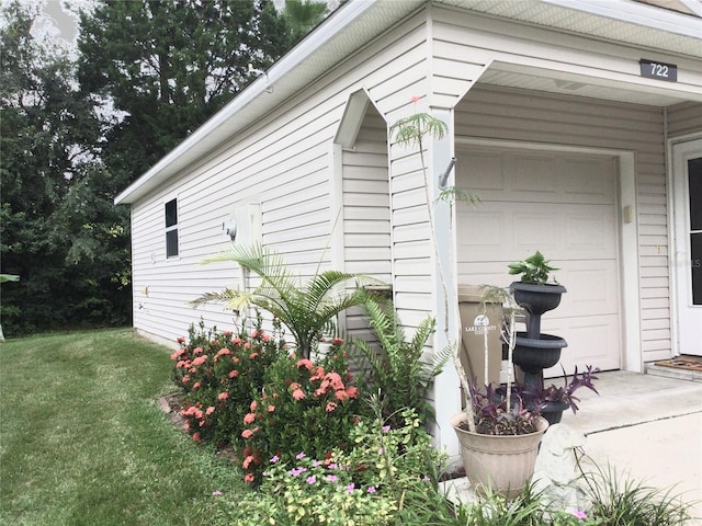 view of side of property with a yard and a garage