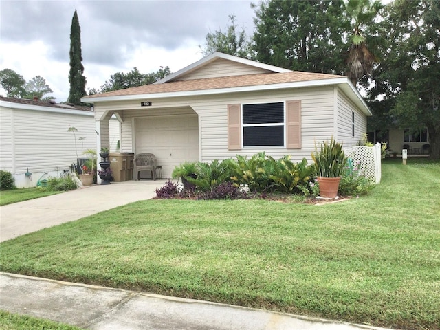 view of front of house with a garage and a front lawn