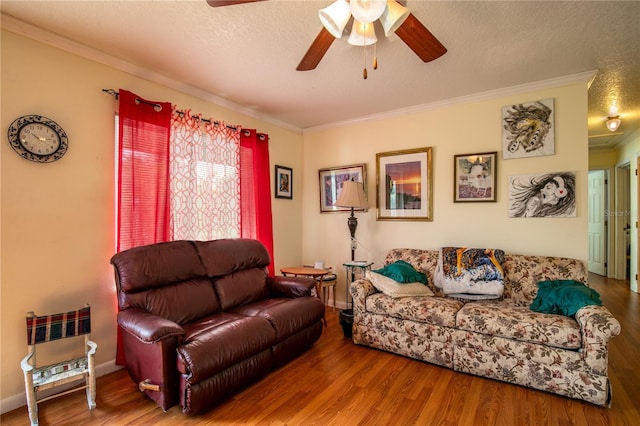 living room featuring a textured ceiling, crown molding, ceiling fan, and hardwood / wood-style floors