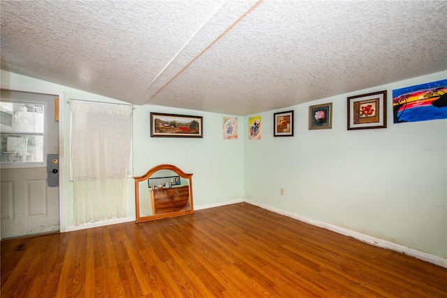 interior space with a textured ceiling and hardwood / wood-style flooring