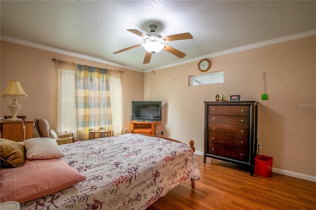 bedroom with crown molding, ceiling fan, and hardwood / wood-style floors