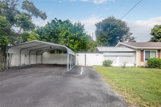 exterior space with a yard and a carport