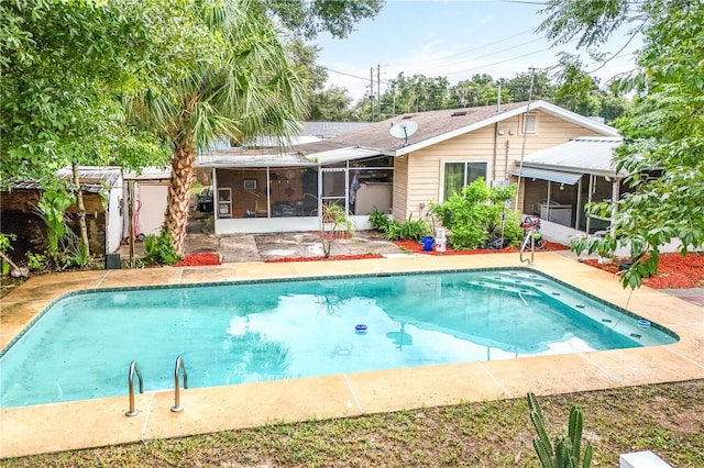 view of pool with a patio and a sunroom