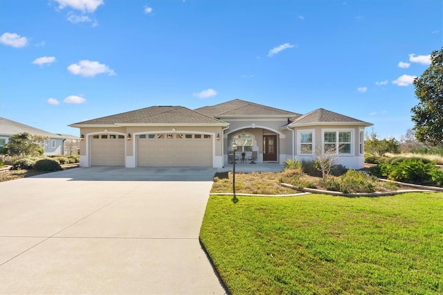 view of front of home with a garage and a front yard