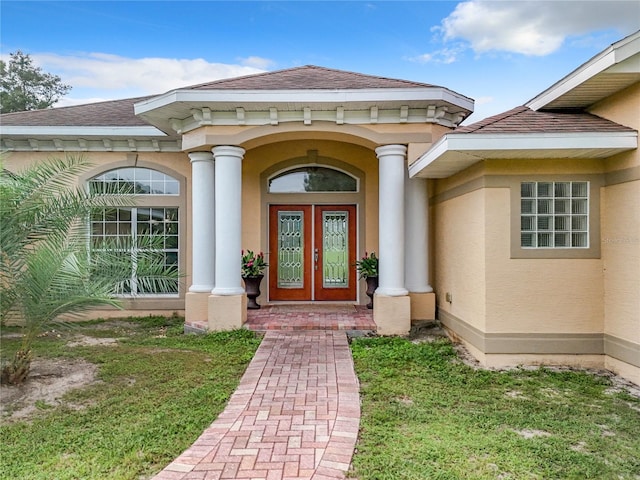 doorway to property with a yard