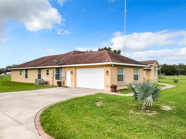 single story home featuring a front yard, a garage, and central AC