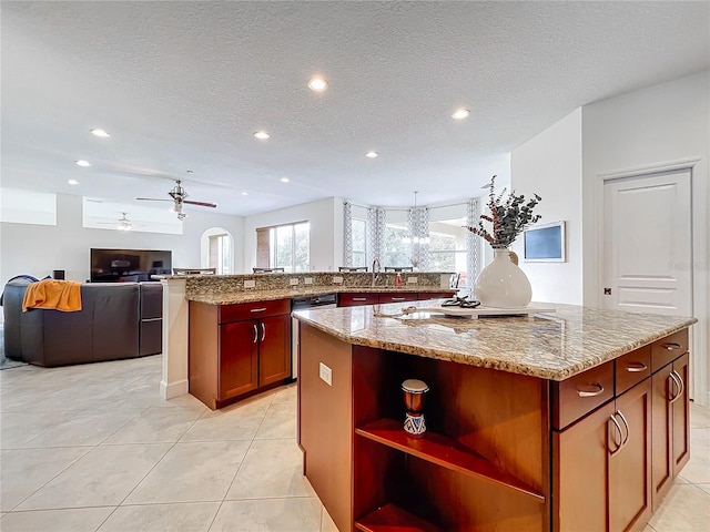 kitchen with a kitchen island, ceiling fan, and plenty of natural light