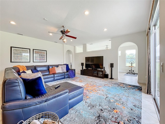 tiled living room featuring ceiling fan