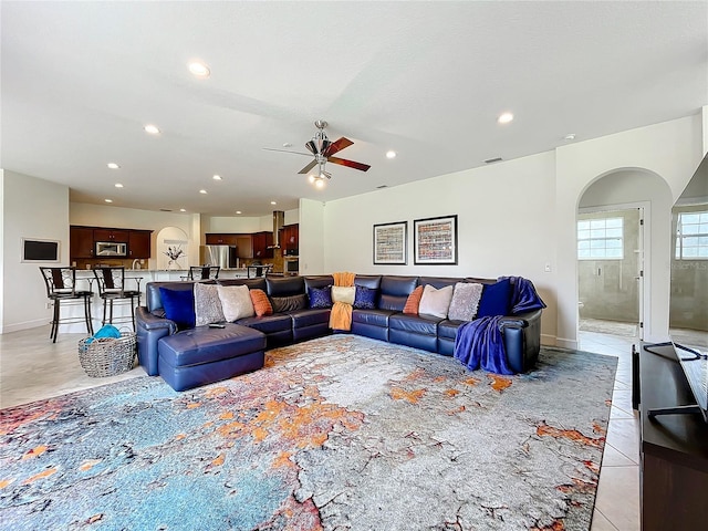 living room featuring ceiling fan and light tile patterned floors