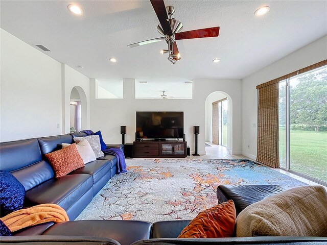 living room featuring a textured ceiling and ceiling fan